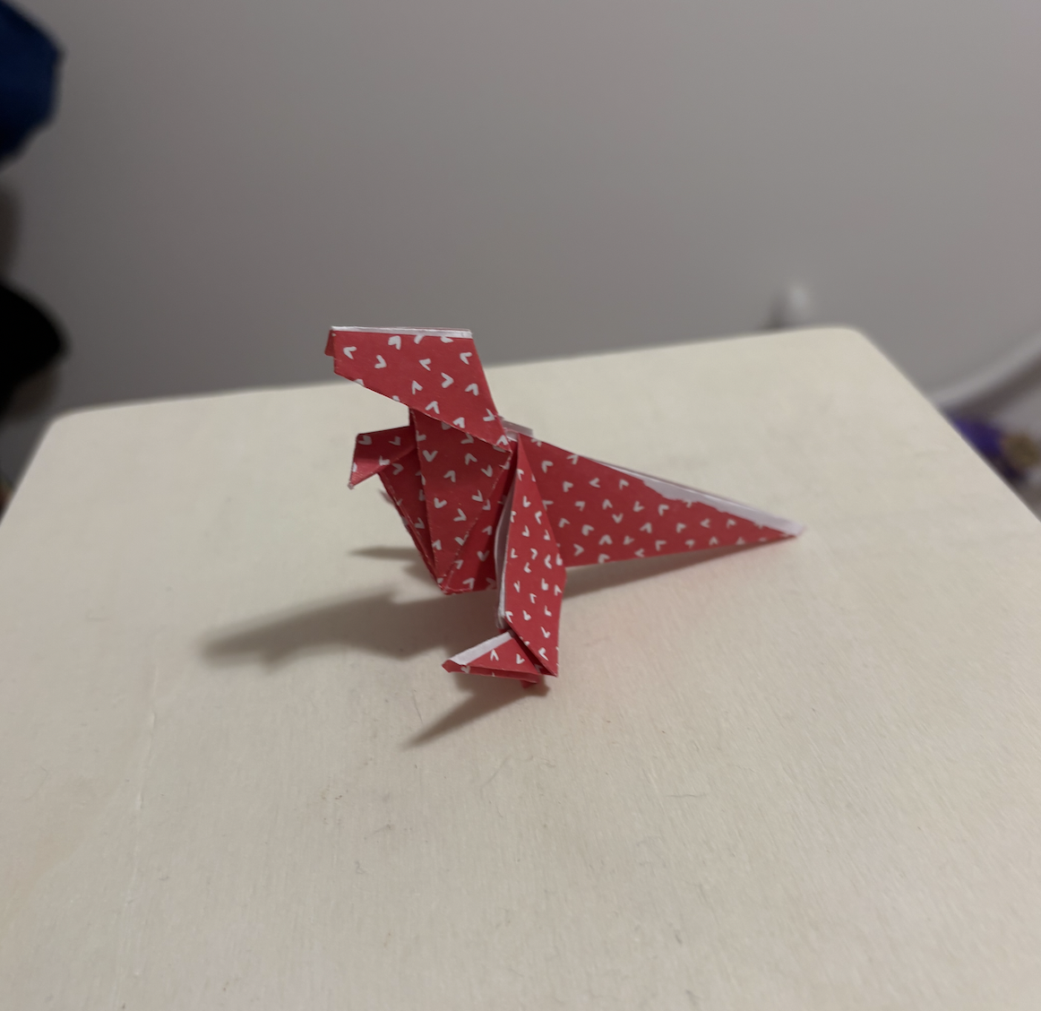 Dinosaur origami, interaction could be on the arms or flaps or the paper origami.